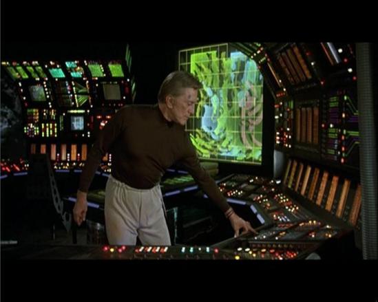 Adam switches the image on the monitor to the lab camera.