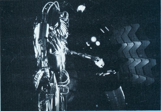 Hector reenters the decontamination chamber after stranding Adam outside (deleted scene).