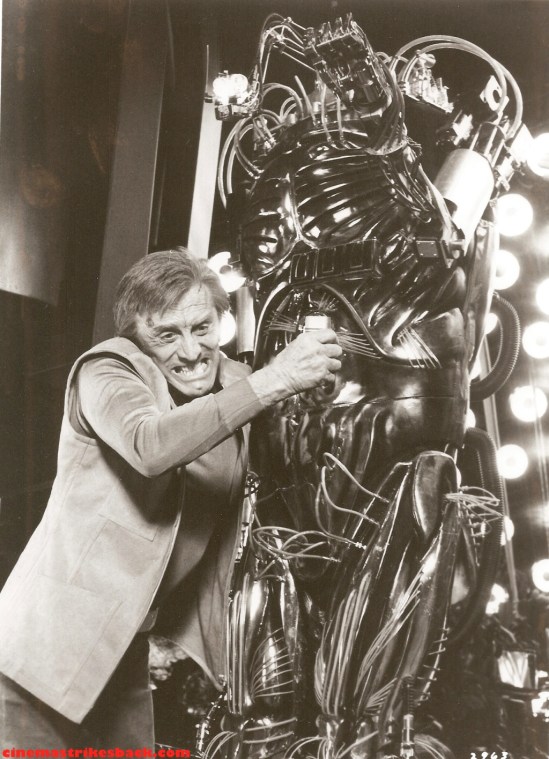 An explosive-laden Adam crashtackles Hector into the sludge pit. (lobby card courtesy cinemastrikesback.com) 